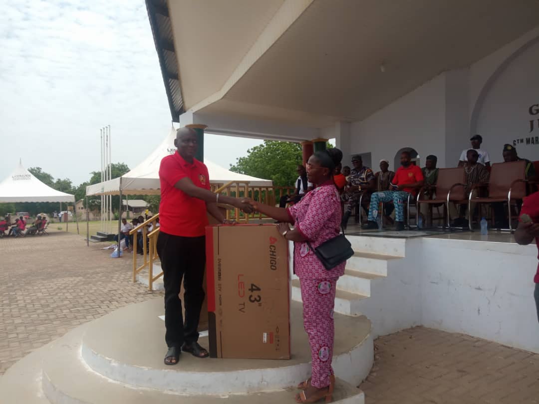 The U/W RCD, Peter Maala presenting an award to Sister Beatrice Dakura 